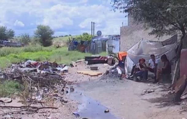 Flash floods destroy makeshift homes, forcing residents to relocate